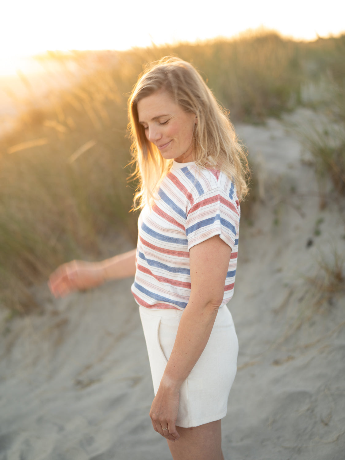 Frauen Ajour Streifenshirt in weiß blau & rot aus 100% Biobaumwolle made in Portugal getragen von Isi am Stand in Portugal.