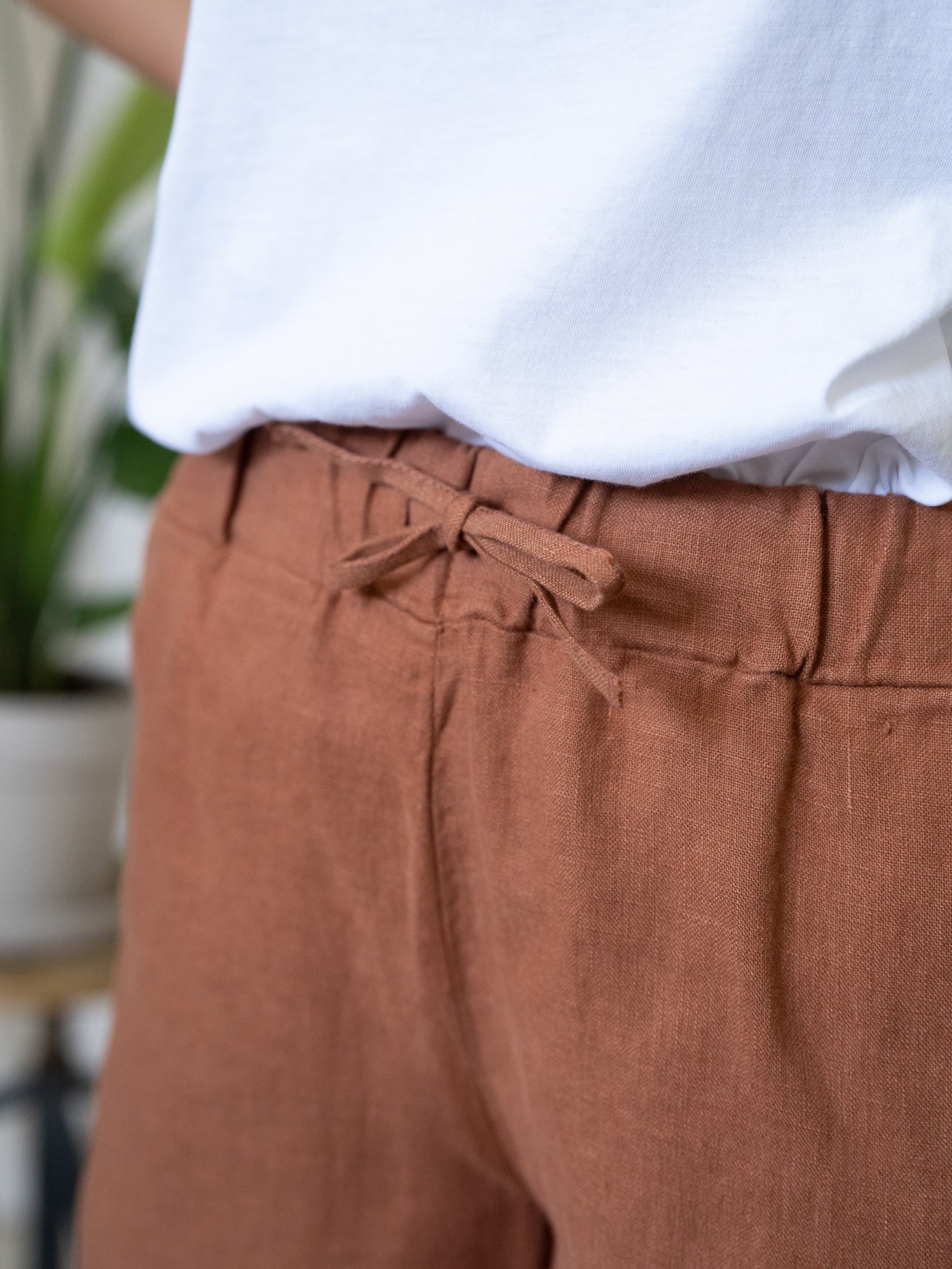 Detailansicht einer nachhaltigen Fair Fashion Frauen Leinenshorts von FUXBAU in Farbe sienna rotbraun aus 100% Leinen.