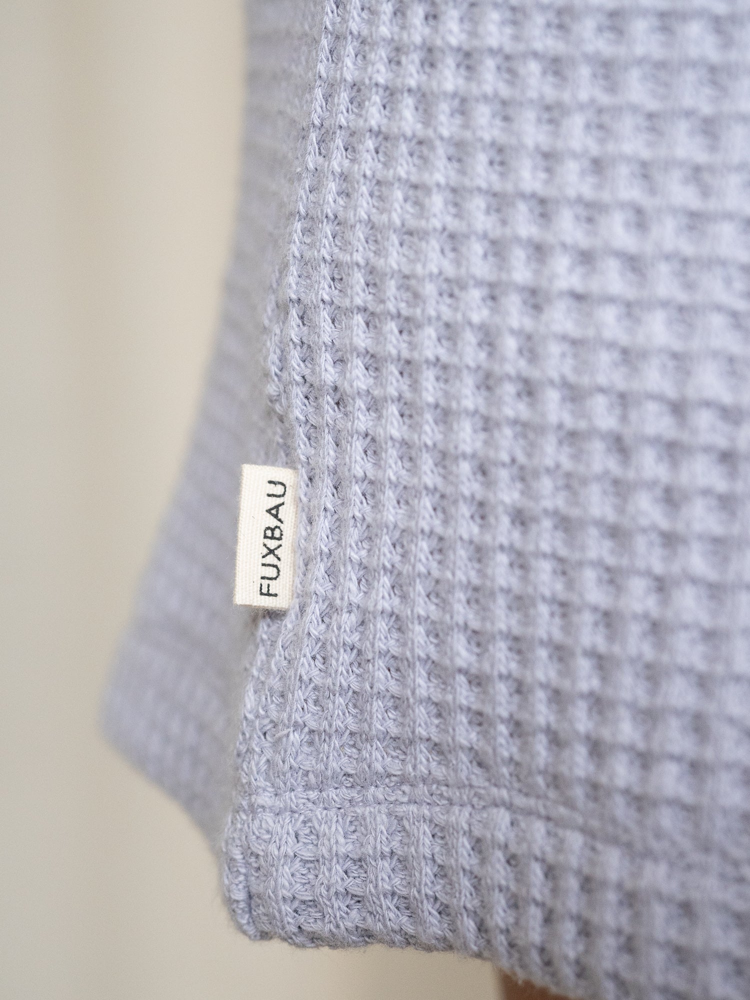 Detailansicht FUXBAU-Label auf den lavendelfarbenen Waffelstrick Shorts – hochwertig verarbeitet aus Bio-Baumwolle