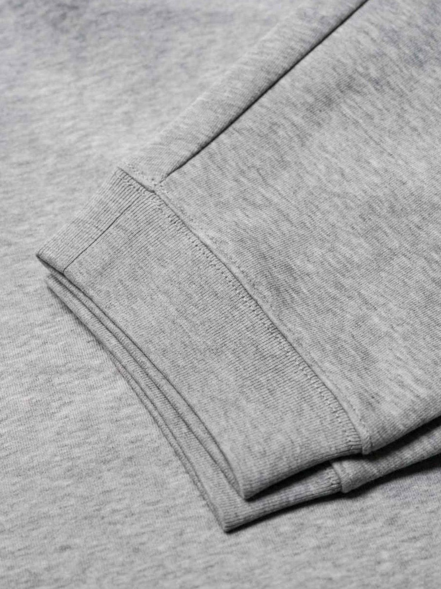 Detailansicht einer nachhaltigen fair fashion Jogginghose von FUXBAU mit grau meliertem Stoff aus Biobaumwolle.