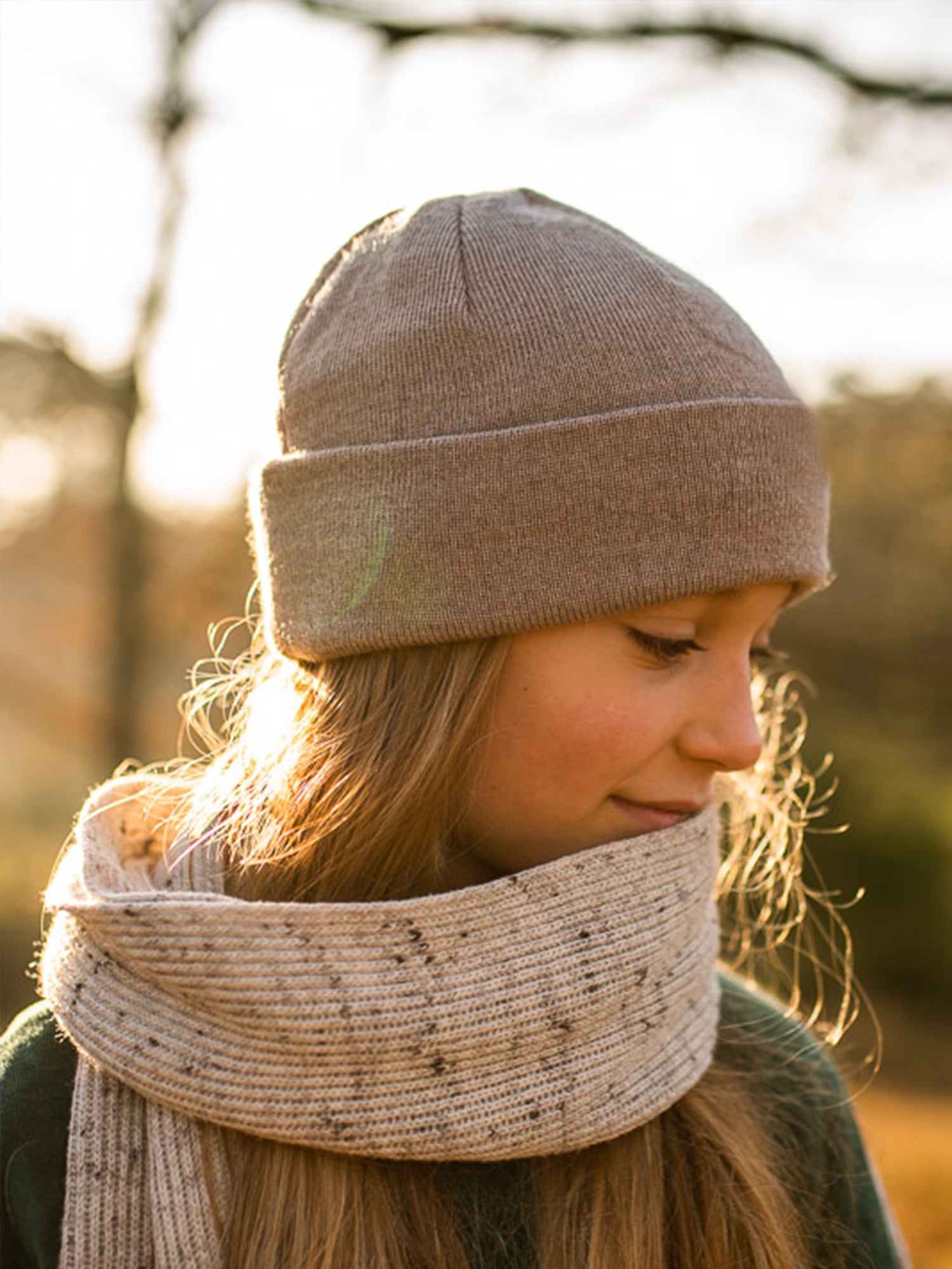 Seitlicheaufnahme eines Mädchens mit sandfarbener FUXBAU Kinder Merino Kork Beanie – nachhaltige Mütze aus 100% Merinowolle, fair produziert in Deutschland.